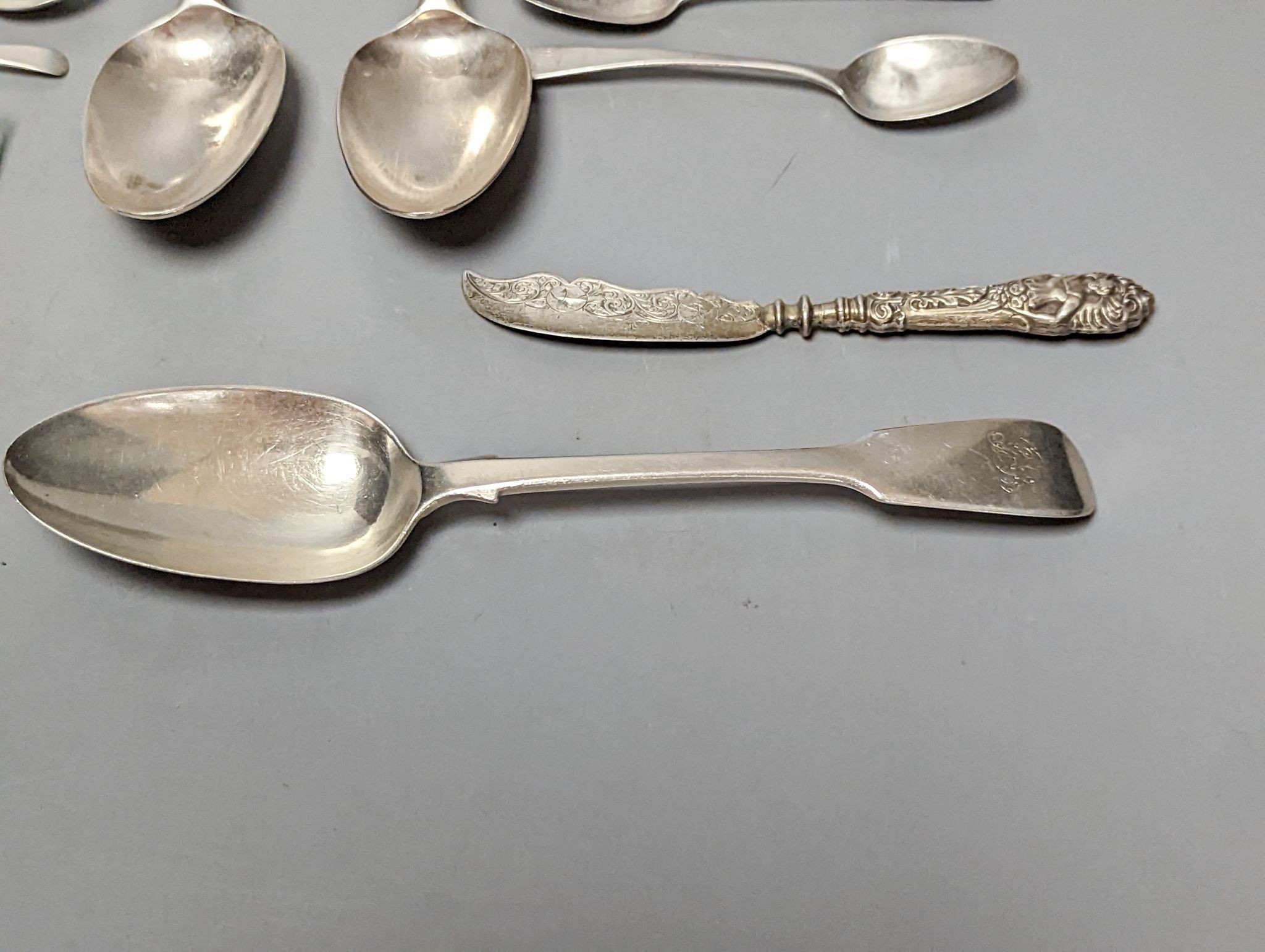 A small quantity of assorted mainly 19th century silver flatware including a pair of George III Old English pattern table spoons, Smith & Hayter, London, 1794 and a silver butter knife, 15oz